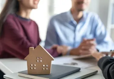 Pam Marron reviewing and signing mortgage papers with a client